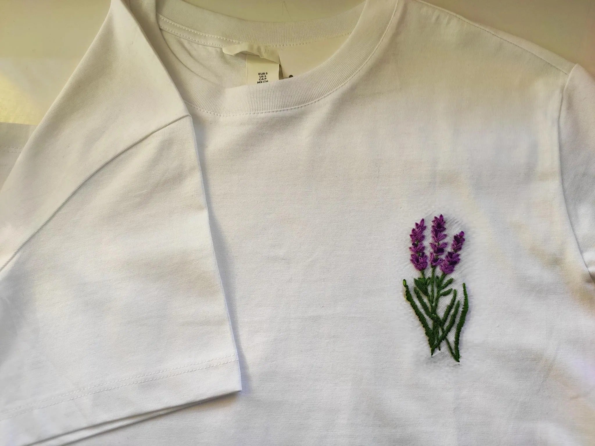 Hand embroidered T-shirt, embroidered lavender. Lavender flowers on t-shirt, t-shirt design Hand embroidered T-shirt, embroidered lavender. Lavender flowers on t-shirt, t-shirt design